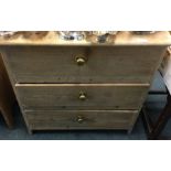 A small pine three drawer chest.