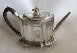 A good Georgian silver teapot of shaped form to cr