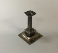 A small Queen Anne silver toy taper stick. Marked