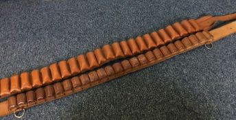 Two leather cartridge belts.