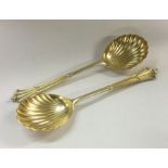 A good pair of silver gilt serving spoons with twi