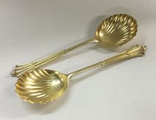 A good pair of silver gilt serving spoons with twi