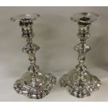 A pair of George II cast silver candlesticks. Lond