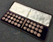 A good cased set of 33 silver buttons together wit