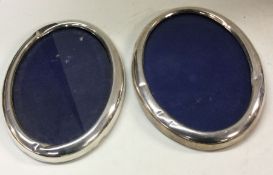 A pair of Sterling silver frames. Marked to side.