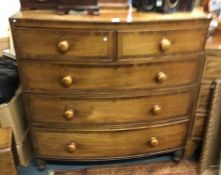 A mahogany bow front chest.