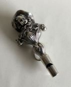 A stylish silver rattle / whistle in the form of a