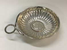 A 19th Century silver wine taster with coin centre