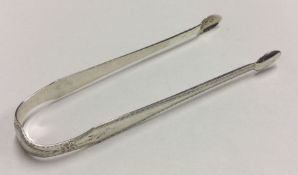 A pair of Georgian bright cut silver sugar tongs.