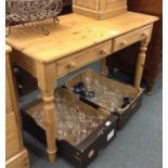 A pine two drawer desk.