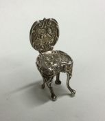 A small silver miniature chair with cherub decorat