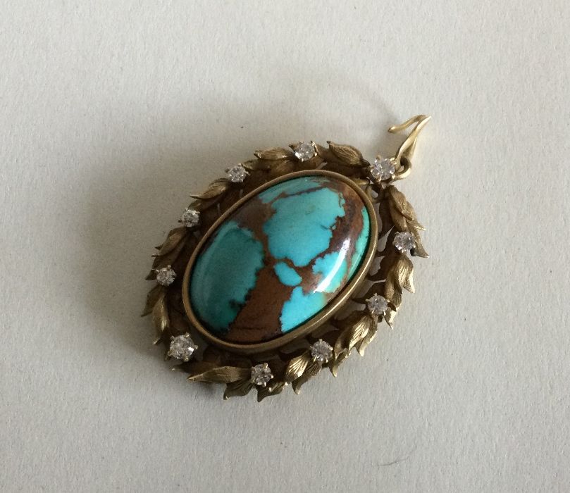 A good turquoise and diamond pendant of stylised f