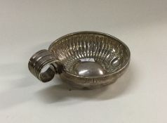 An Antique French silver wine taster with chased d