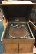 A HMV gramophone together with a cabinet of gramophone records.
