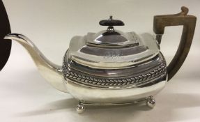 A decorative George III silver teapot with chased