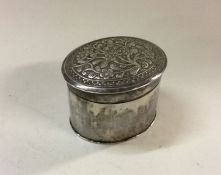 A Chinese silver pill box and cover decorated with