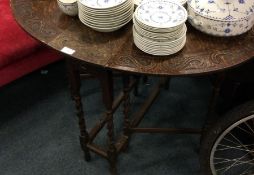 An oak carved drop leaf table.