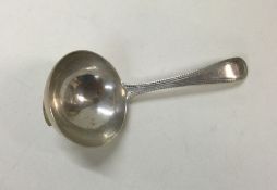 A heavy George III silver caddy spoon. London 1784