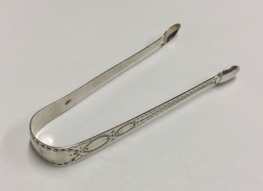 A pair of Georgian bright cut silver sugar tongs.