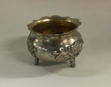 A chased Chinese silver bowl on feet decorated wit
