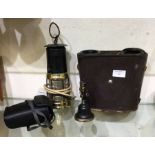 An old minors lamp together with binoculars etc.