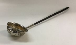 A chased George III silver toddy ladle with whaleb