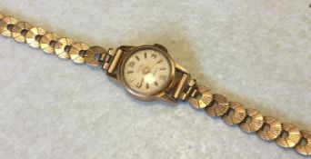 A lady's 18 carat gold wristwatch on 9 carat strap
