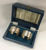 A pair of cased silver napkin rings. Approx. 60 gr