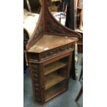 A Continental oak corner cupboard on stand.