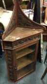 A Continental oak corner cupboard on stand.