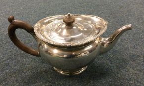 A heavy silver teapot with shell border. Birmingha