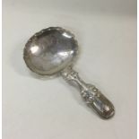 A George III silver caddy spoon. Birmingham 1819.