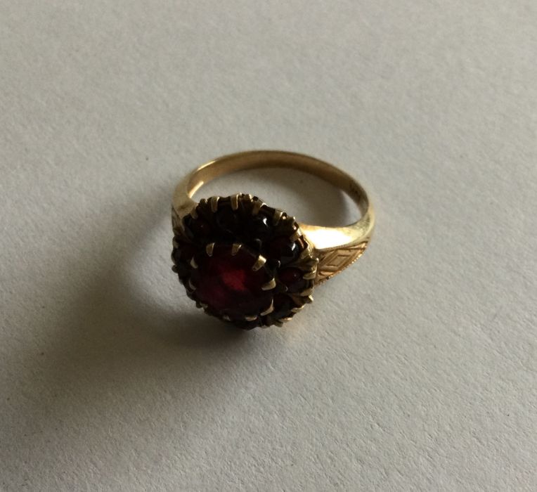 A heavy 9 carat garnet ring. Approx. 3 grams. Est.