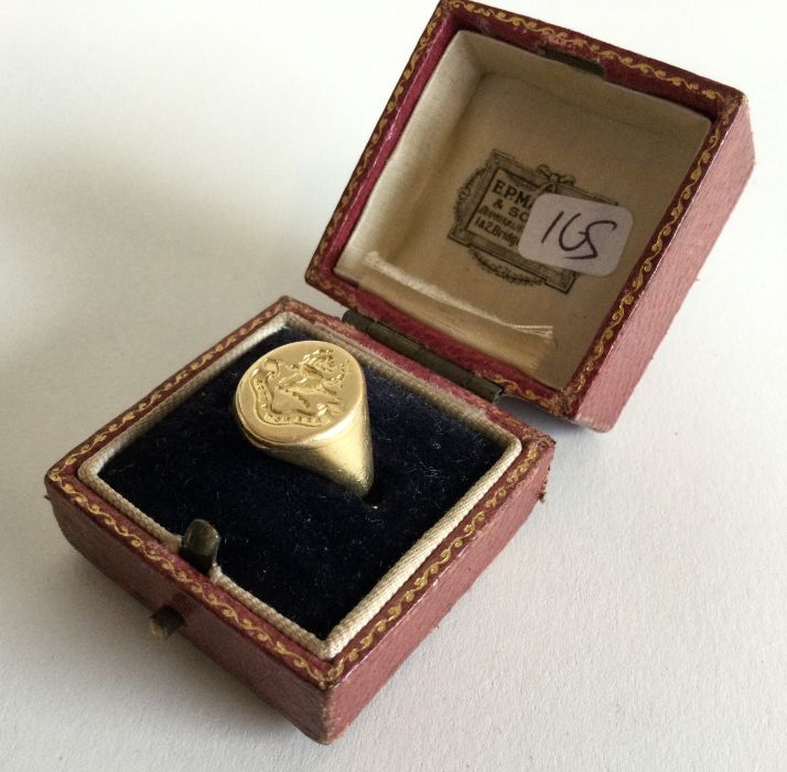 An 18 carat gold crested signet ring of oval form.