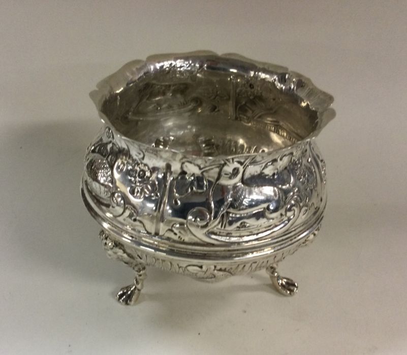A chased Victorian silver dish decorated with anim