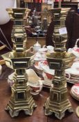 A pair of Chinese brass candlesticks.