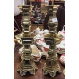 A pair of Chinese brass candlesticks.