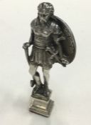 A heavy silver seal in the form of a warrior. Lond