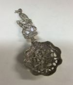 A Continental silver caddy spoon decorated with a
