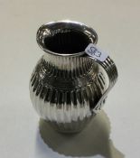 A heavy Victorian silver cream jug with fluted bod