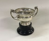 A silver two handled cup on plinth base. Birmingha
