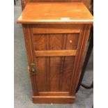 A mahogany bedside cabinet.