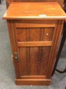 A mahogany bedside cabinet.