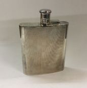 A large engine turned silver flask with screw-on l