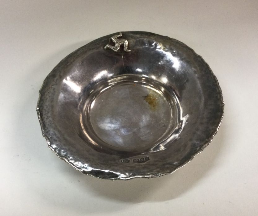 A silver dish of hammered design. London 1981. By