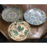 A group of three large Continental pottery plates.