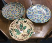 A group of three large Continental pottery plates.