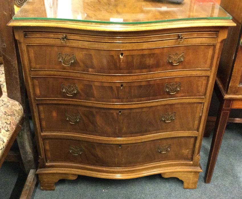 A mahogany bow front chest of four drawers.