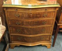 A mahogany bow front chest of four drawers.