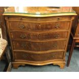 A mahogany bow front chest of four drawers.